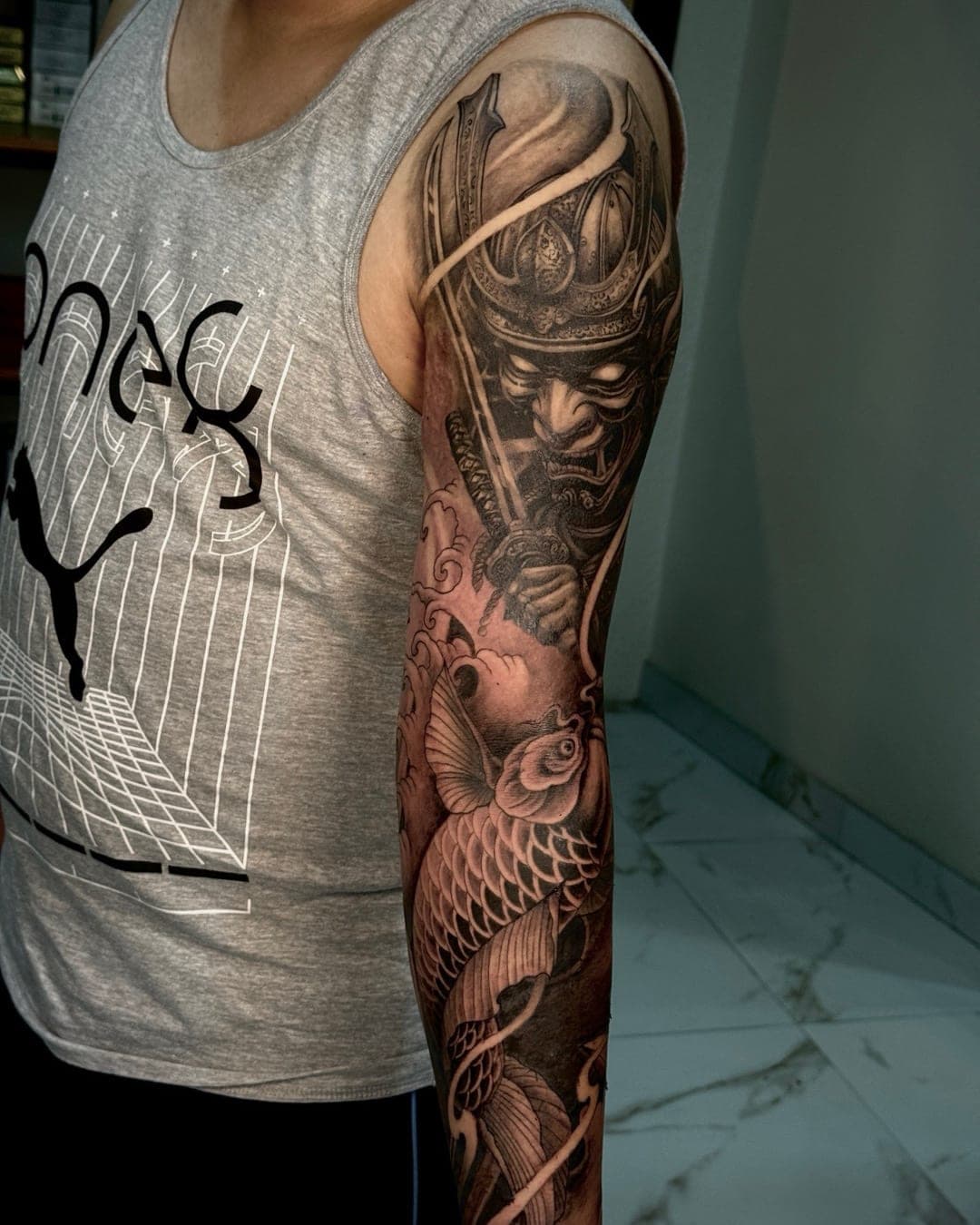 Black and grey samurai and koi sleeve tattoo completed at Anands Tattoo in Lakeside, Pokhara